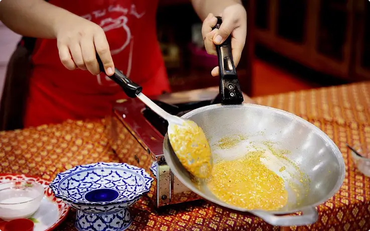 Visitors cooking at Sompong Cooking School in Bangkok