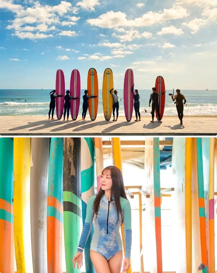 Visitors taking photos with surfboards at Songjeong Beach in Busan