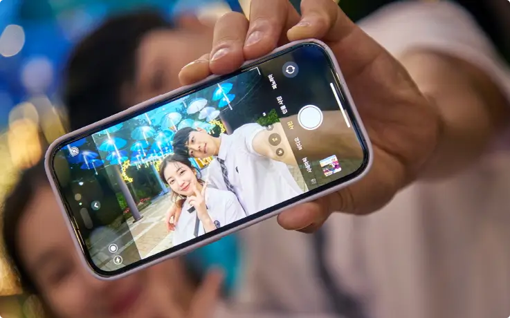 Visitors wearing Korean school uniforms taking a selfie at Daegu E-World