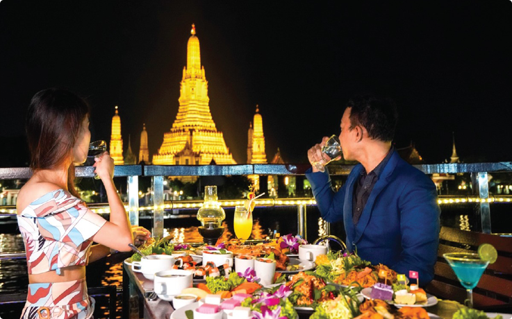 Visitors enjoying dinner aboard the White Orchid River Dinner Cruise