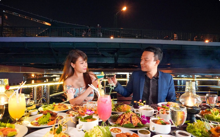 Visitors enjoying dinner aboard the White Orchid River Dinner Cruise