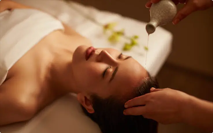 People getting warm oil head massage at Diora Luxe Asoke Spa in Bangkok