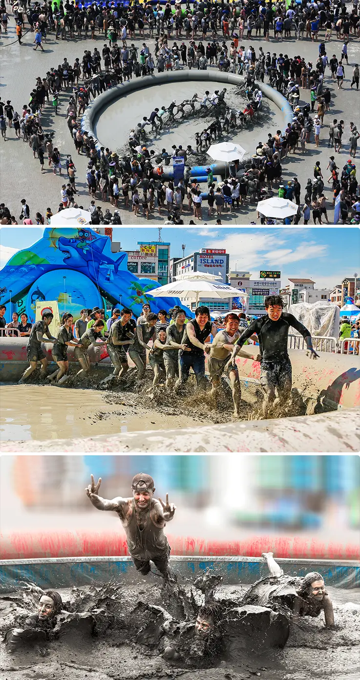 Festival-goers competing in inflatable mud pool games.