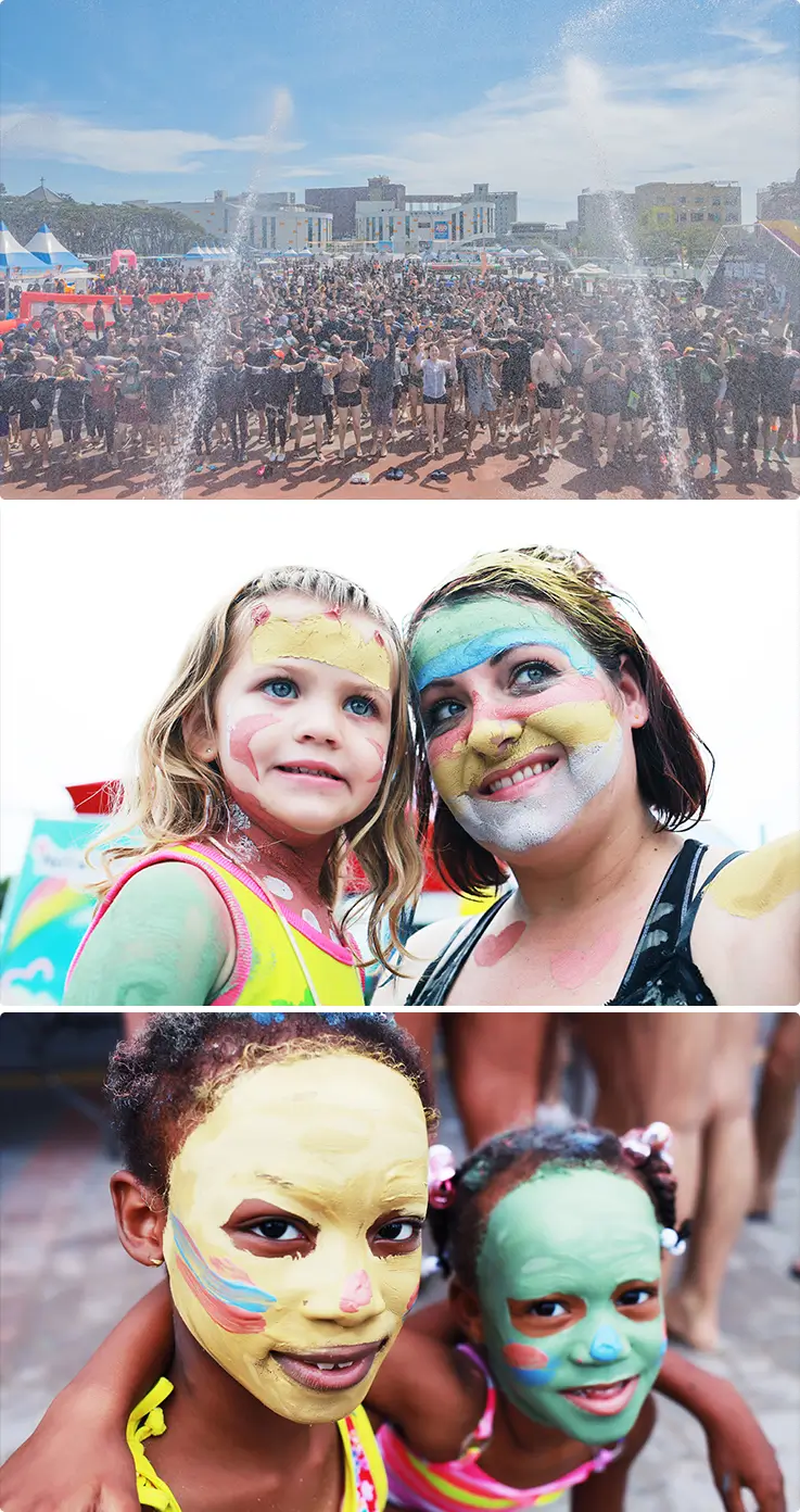 Colorful mud face paint delighting kids and families.