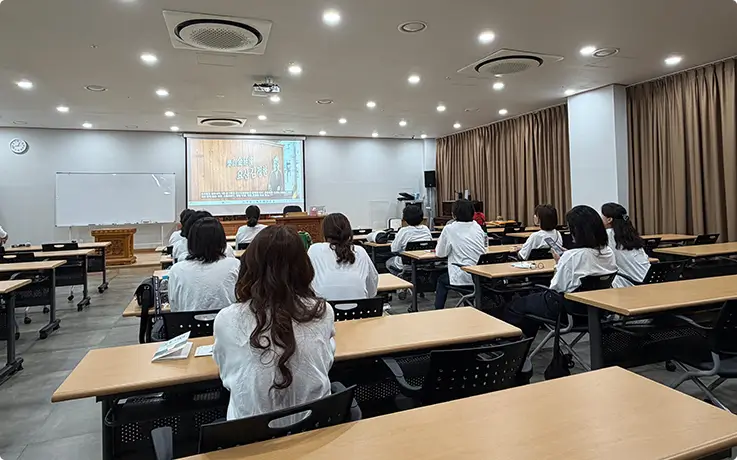 Participants attend an indoor literary content session before beginning the hand-copying activity.