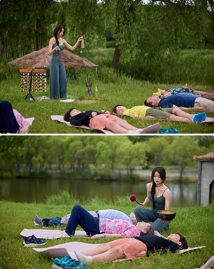 Outdoor sound healing therapy session with singing bowl practice beside a tranquil riverside meadow.