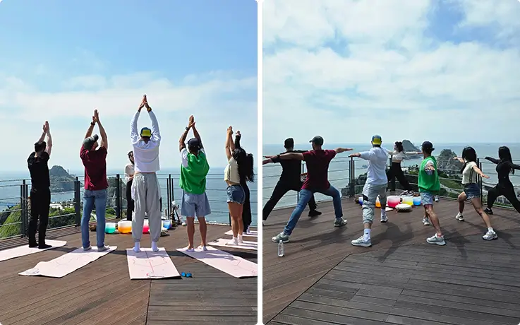 People posing on a cliffside deck overlooking the ocean.