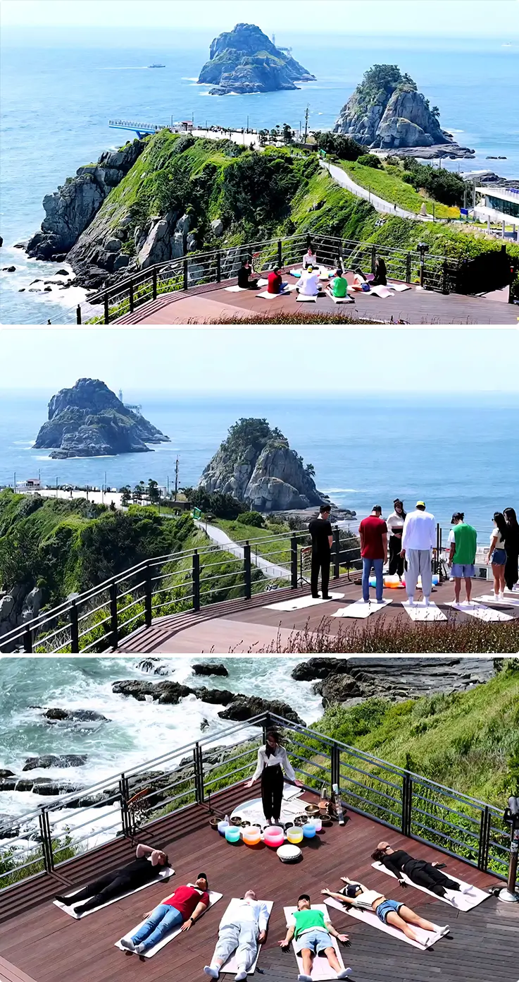 Outdoor singing bowl meditation sessions on a clifftop deck with dramatic views of Oryukdo islets and the open sea.
