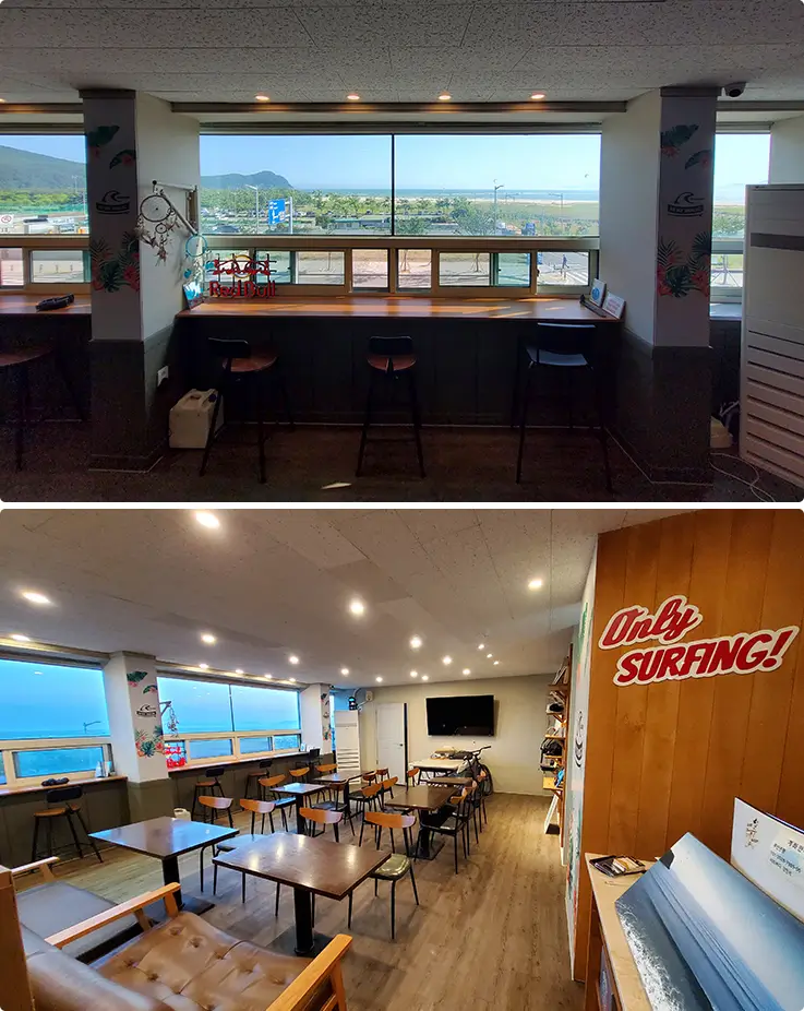 Cozy Surfholic lounge and cafe space with ocean-view seating and surf decor.