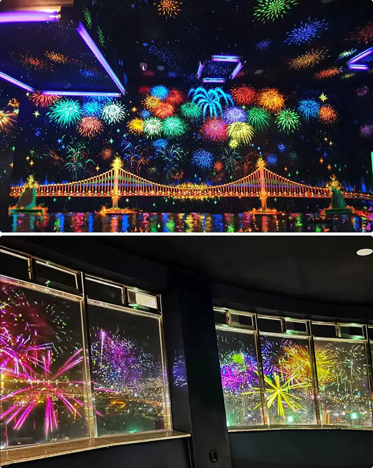 Colorful fireworks mapping show illuminating Busan Tower's observatory windows and mural ceiling display.
