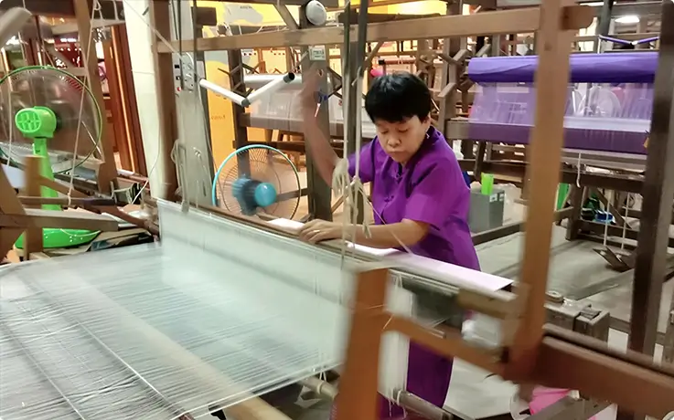 A man weaving silk at the Thai Silk Village in Chiang Mai