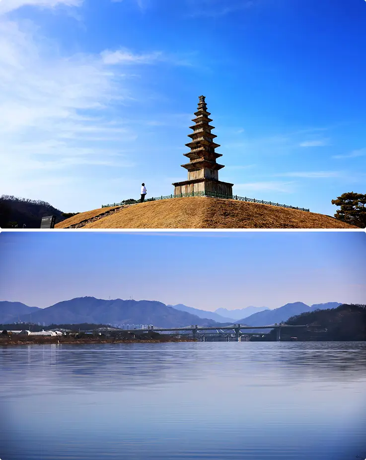 Ancient seven-story stone pagoda overlooks scenic riverside park and layered mountain views.