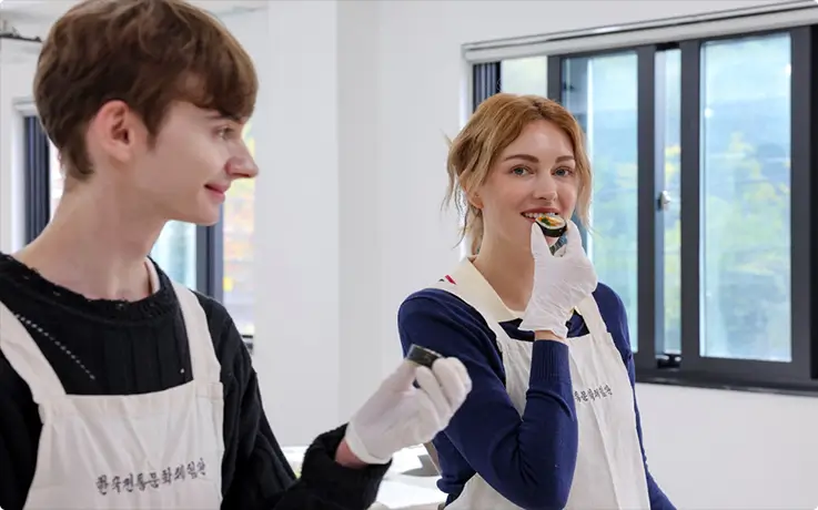 Guests taste freshly made Korean gimbap, savoring flavors from their own cooking.