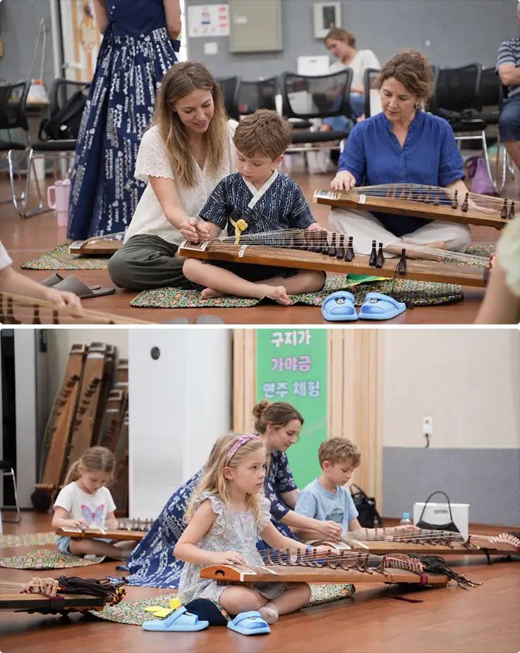 Guests of all ages practice playing the gayageum during a group session.