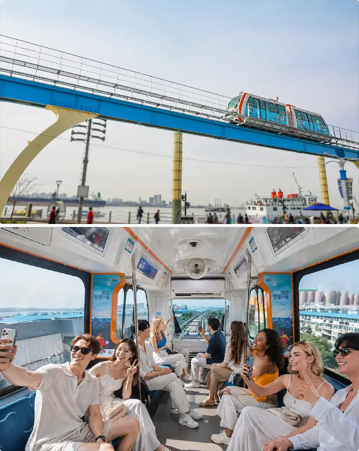 Wolmi Sea Train gliding along an elevated coastal track, with riders enjoying scenic views inside.