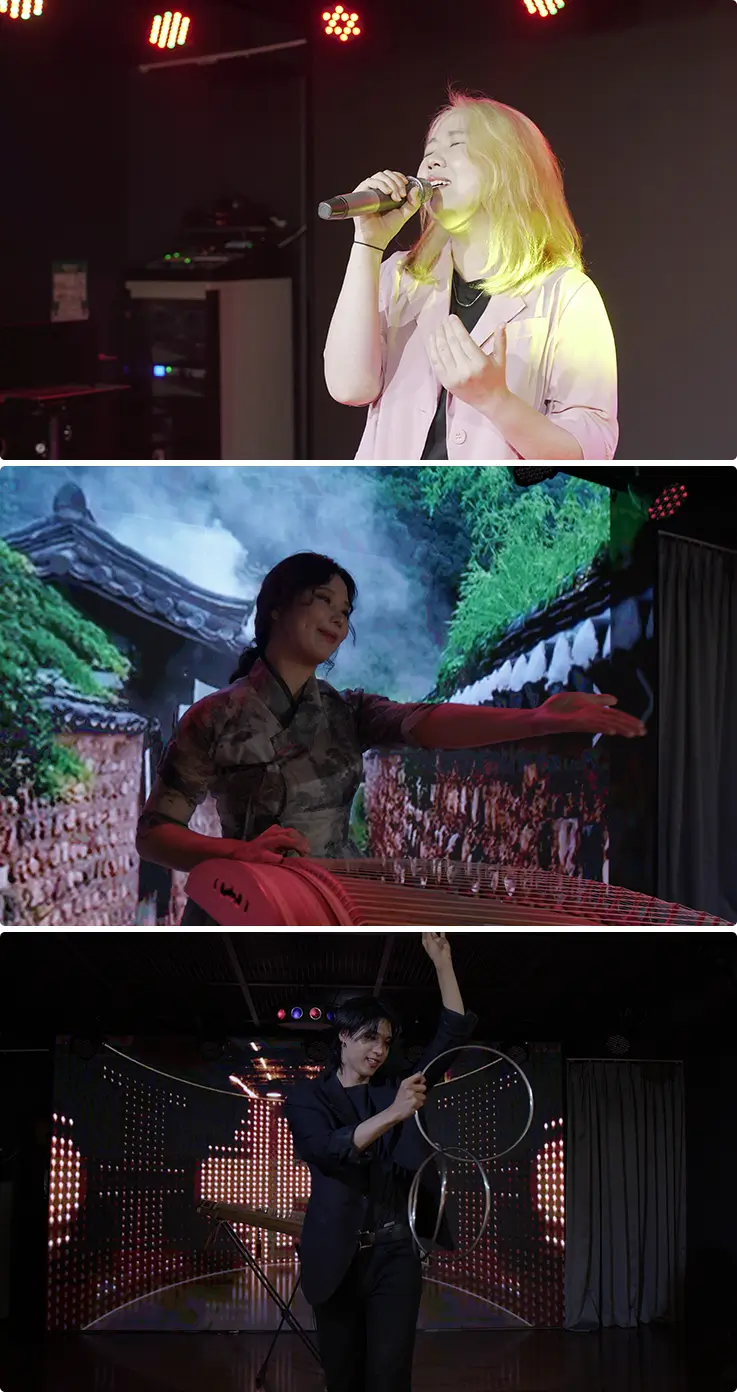 Live singer, traditional gayageum performance, and hoop magic act on stage.