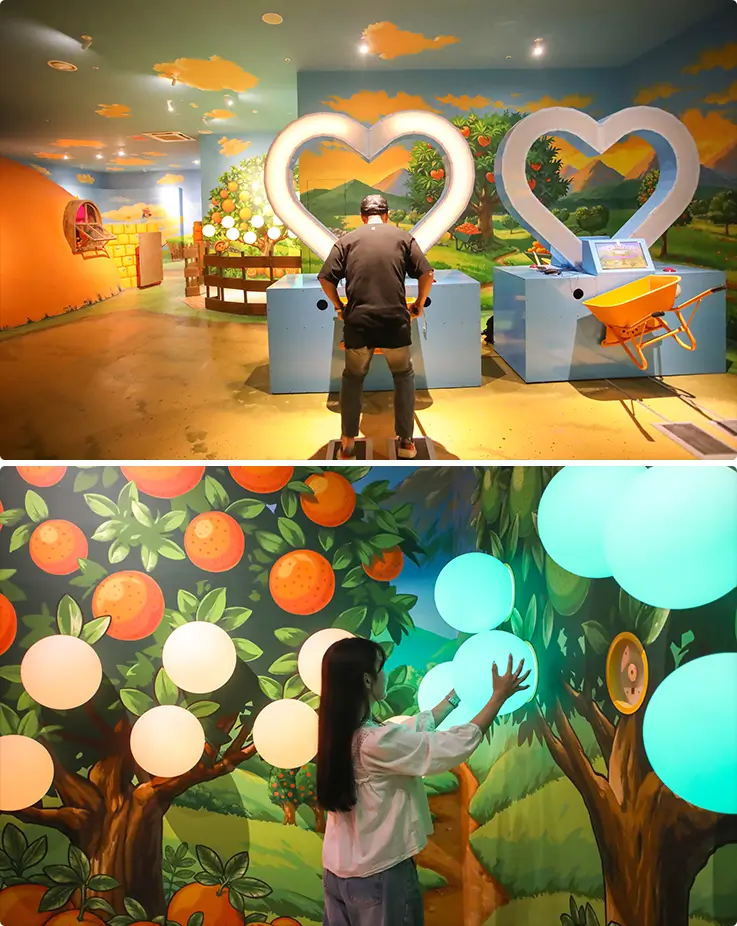 Interactive citrus-themed trick art zone with glowing tangerine installations and heart-shaped photo frames at Baksal2: K-Island Jeju.