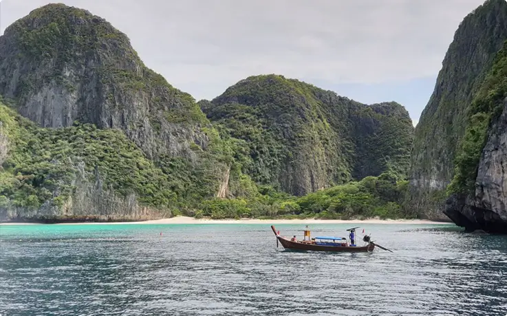 People riding a boat on Pileh Bay of Phi Phi Island in Krabi