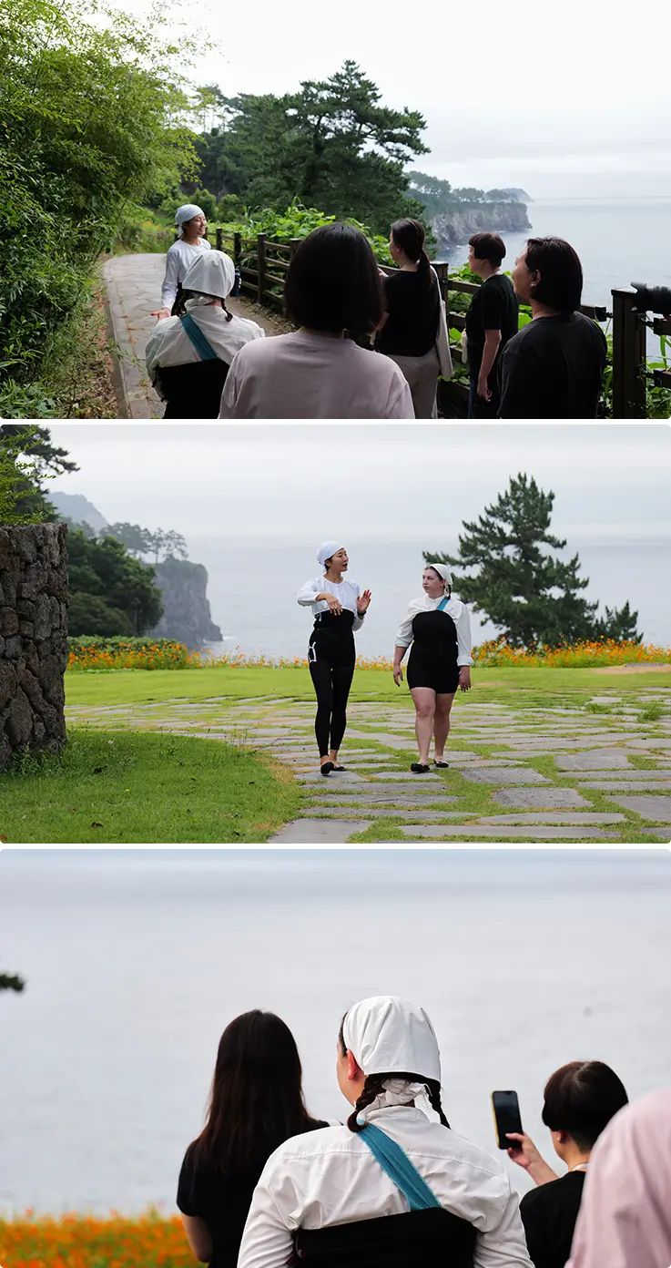 Haenyeo leads guests on a scenic coastal walk along Jeju Olle Trail.