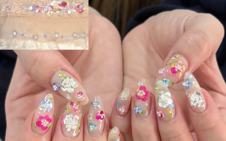 Ang:tt 3D flower nail art with sequins and gems on sheer almond nails.