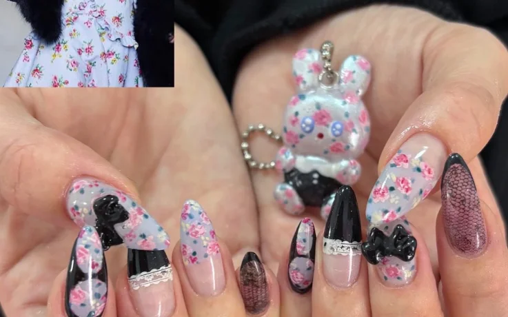 Floral and lace Ang:tt nail art with black 3D bows, inspired by a vintage dress.