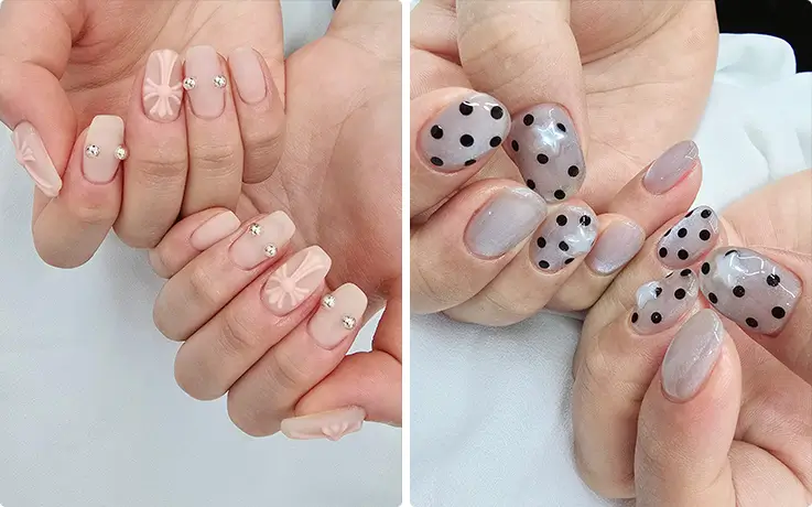 Trendy Korean nail art with floral crystal accents and chic black polka dot gel designs.
