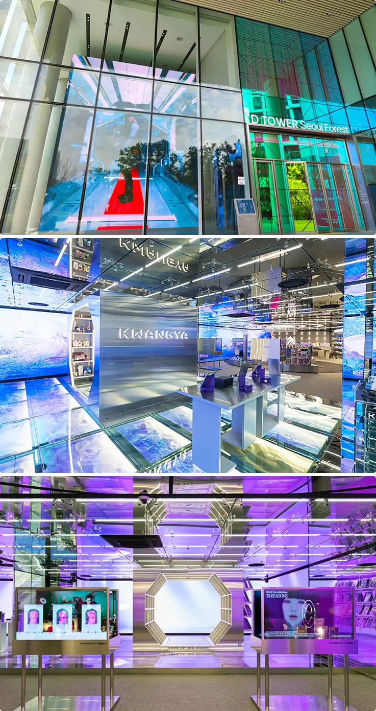 Futuristic glass tower entrance leading into a sleek K-pop concept space.