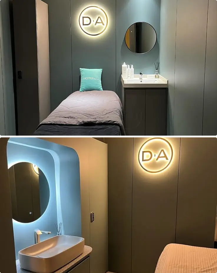 Luxurious DA Clinic private recovery room with branded illuminated logo and amenities.