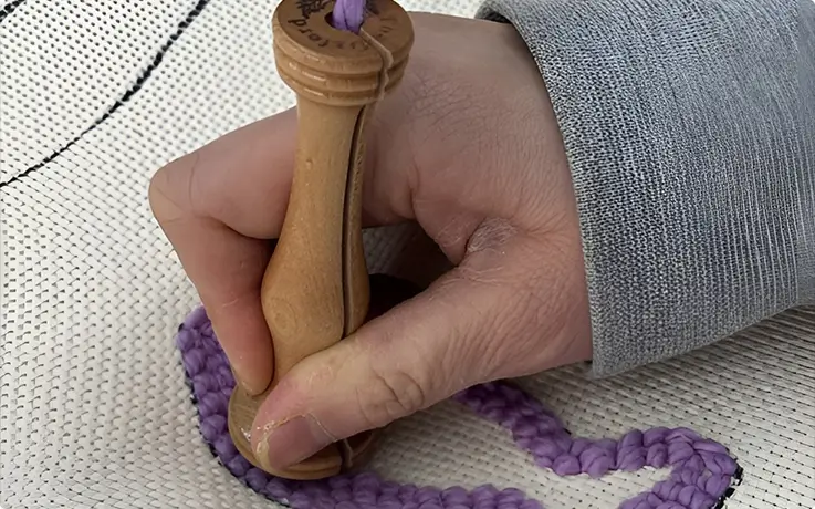 A person making lucky dried pollack with a punch needle at Gre Island Studio in Seoul