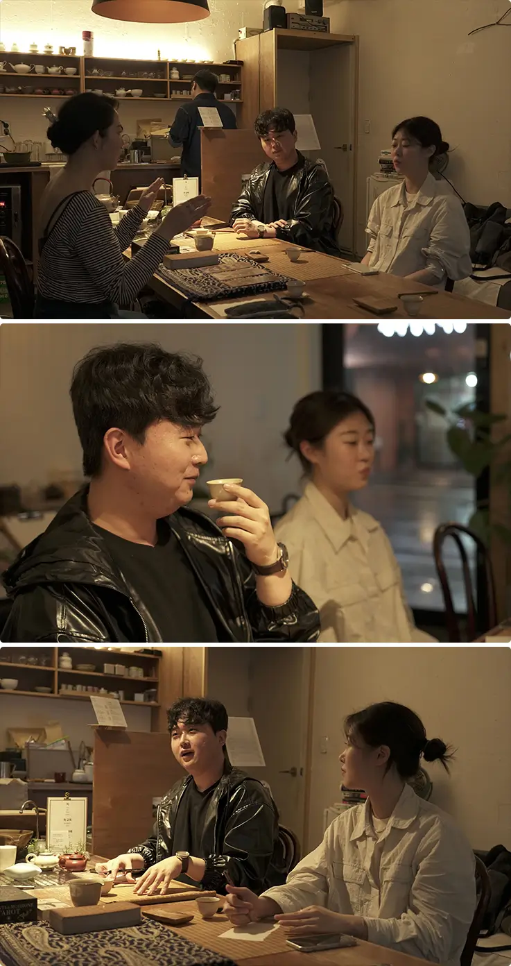 Guests engaging in lively conversation and tasting tea during Korean cultural experience.