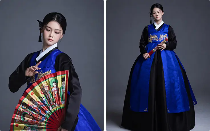 The minyo instructor wears a striking blue and black hanbok with a fan.