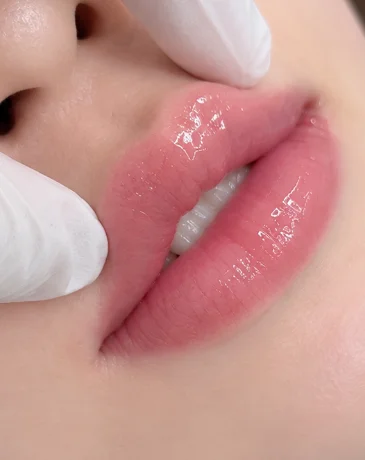 Korean lip blush PMU result with soft, natural rosy color and glossy shine.