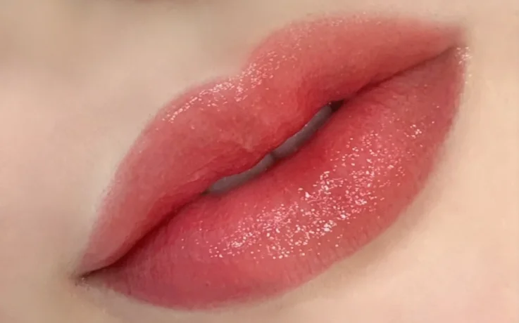 Korean lip blush PMU showing soft, natural watercolor lips in rosy tones.