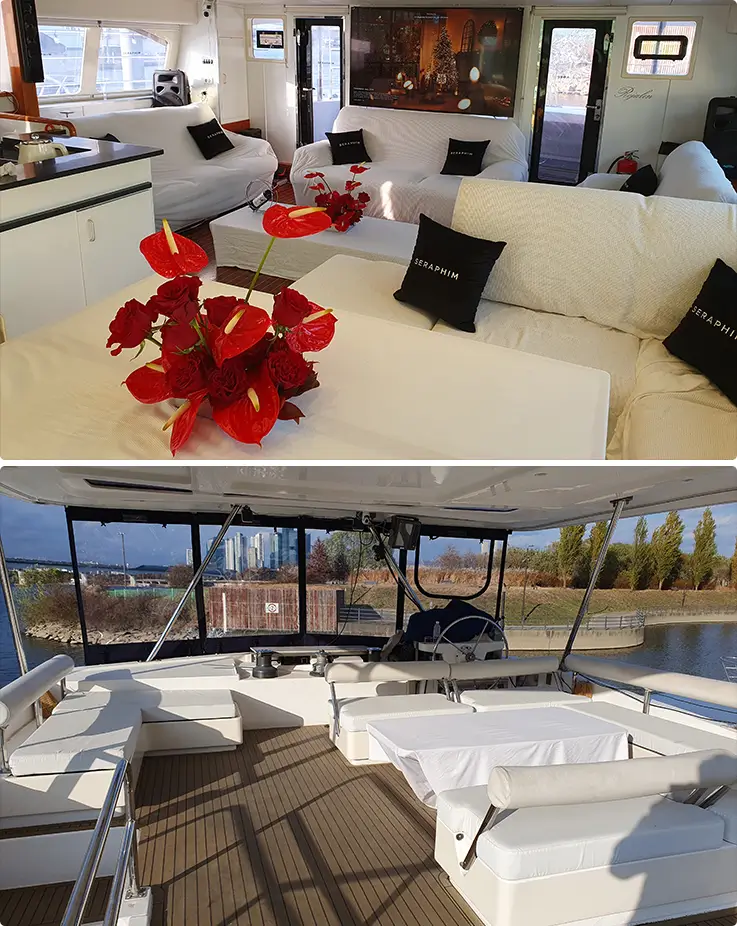 Rozalin's elegantly furnished cabin with white sofas and red floral accents, alongside a sun-drenched open rear deck.