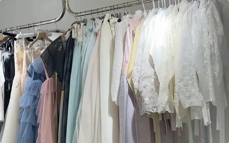 Premium Hanbok collection rack showcasing elegant pastel and lace traditional Korean dresses.