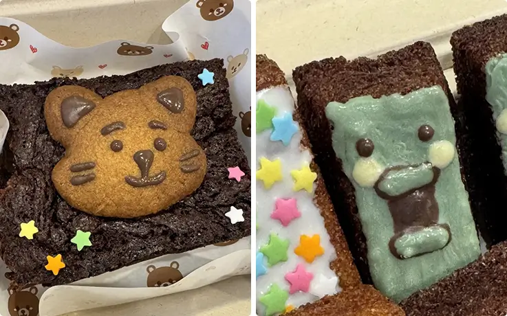 Decorated chocolate brownie with cookie topper and star-sprinkled brownies with cute faces.