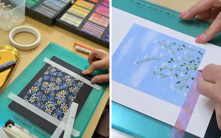 Participants taping paper and creating floral oil pastel artworks during Suwon class.