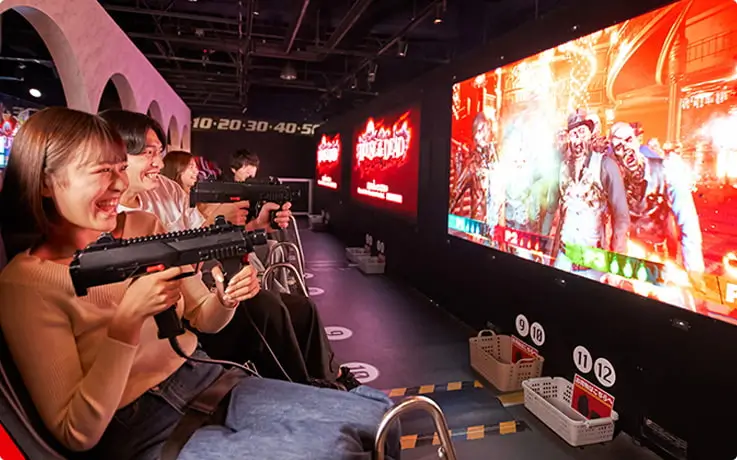Visitors playing House of the Dead at Tokyo Joypolis