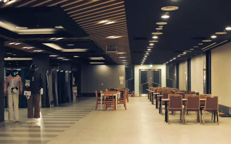 Roomy exclusive guest lounge with ample seating, fitting rooms, and premium ski wear displays.