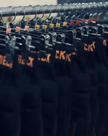 Rack of size-tagged protective hip pads ready for rent at the Oak Valley guest lounge.