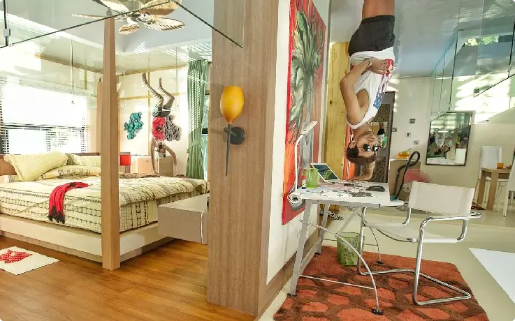 Visitors posing inside Phuket’s Upside Down House with inverted furniture and décor 1