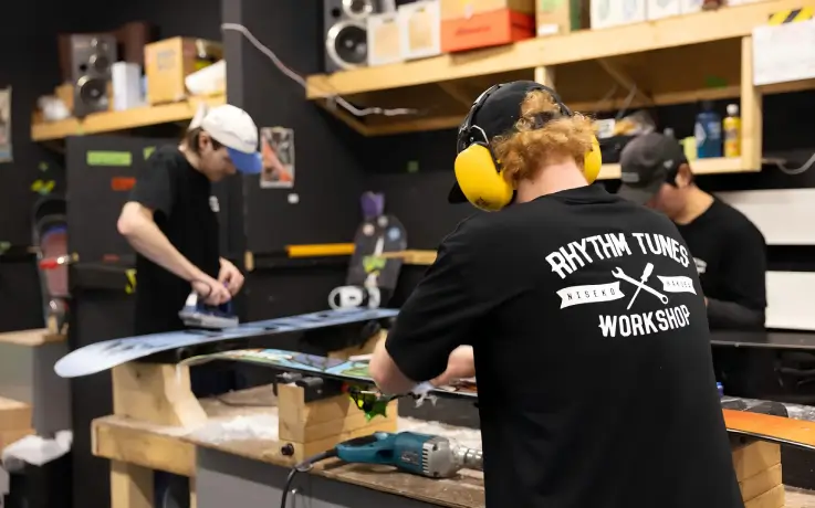 Snowboards undergoing maintenance at Rhythm Hirafu Niseko