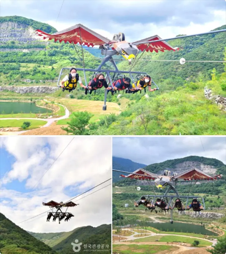 Visitors soaring over a valley on an eagle-shaped sky glider at Mureung Byeolyucheonji.