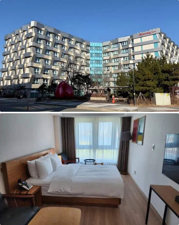 Exterior view of Sokcho Marina Bay Hotel overlooking the marina and nearby coastline.