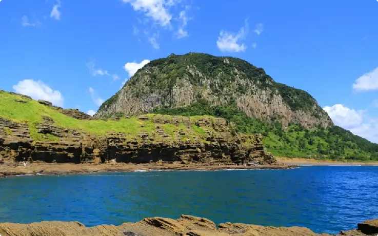 Cliffside rock formations and coastal scenery at Yongmeori Coast, Jeju.